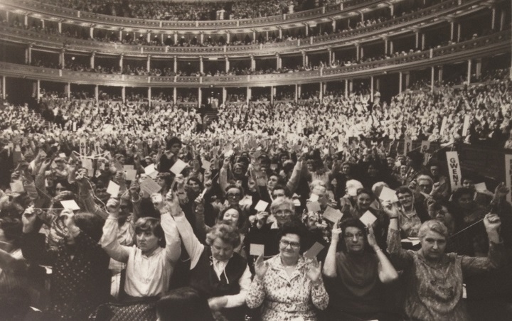 Black and white photo of WI members voting at the Annual Meeting