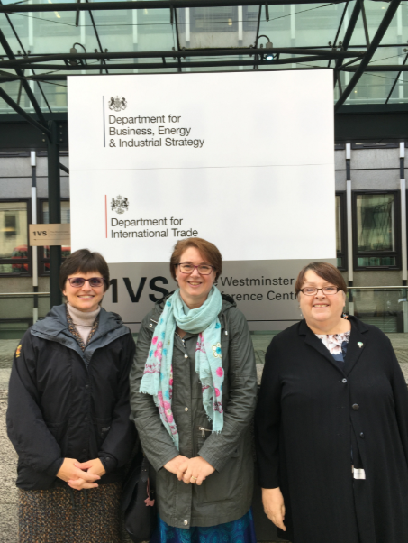 3 women standing outside, in front of the Department for Business, Energy & Industrial Strategy