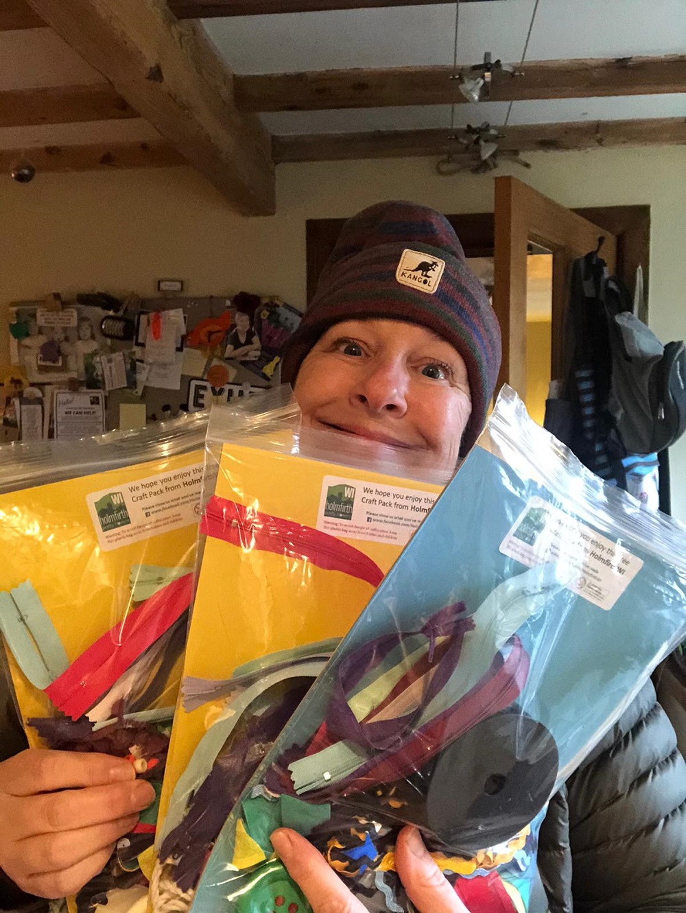 A woman holding a number of bags with craft items in her hands