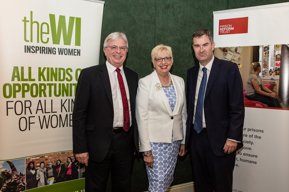 NFWI Chair Lynne Stubbings next to two men at an event for the Care not Custody campaign