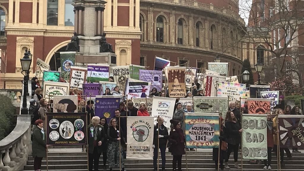 WI members in front of the Royal Albert Hall holding up placards 